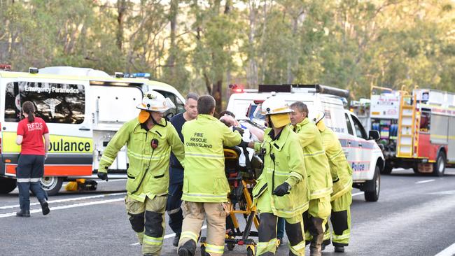 Patients are transported to the waiting helicopters at the scene of a double fatality.