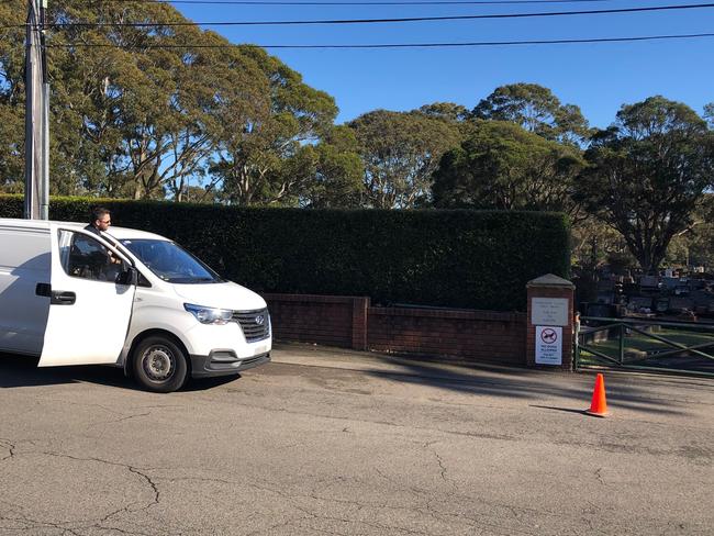 A NSW Police forensics officer about to enter the Frenchs Forest Bushland Cemetery to examine the graves' desecration site. Picture: Jim O'Rourke