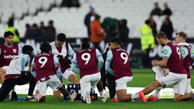 West Ham United's team-players wear the shirt of his teammate West Ham United's English forward #09 Michail Antonio as part of tribute following his car accident, during the warm-up prior to the English Premier League football match between West Ham United and Wolverhapton Wanderers at the London Stadium, in London on December 9, 2024. West Ham said forward Michail Antonio has undergone surgery on a lower limb fracture after a serious car accident on December 7, 2024. (Photo by Adrian Dennis / AFP) / RESTRICTED TO EDITORIAL USE. No use with unauthorized audio, video, data, fixture lists, club/league logos or 'live' services. Online in-match use limited to 120 images. An additional 40 images may be used in extra time. No video emulation. Social media in-match use limited to 120 images. An additional 40 images may be used in extra time. No use in betting publications, games or single club/league/player publications. /