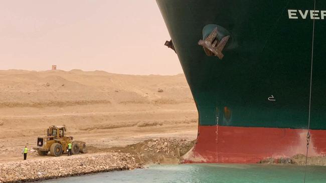 Heavy machinery attempts to dig out the giant cargo ship. Picture: Suez Canal Authority/AFP