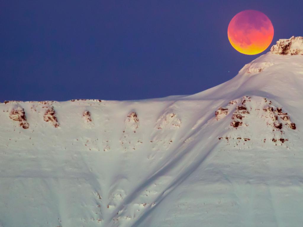 A super blue blood moon behind a mountain is seen from Longyearbyen, Svalbard, Norway, on January 31, 2018. Picture; AFP