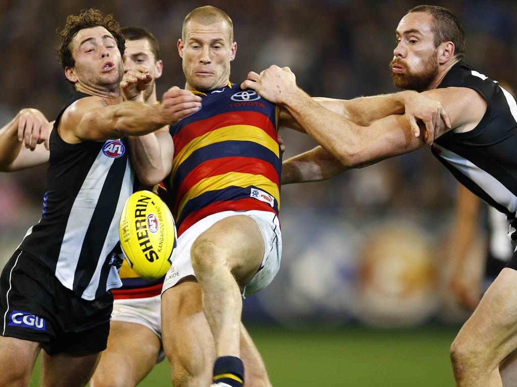 2013 - It’s going to take more than two Magpies to stop Scott Thompson from getting his kick away at the MCG.