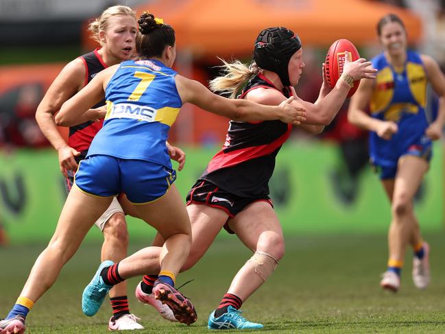 Chloe Adams weaves her way through traffic on AFLW debut. Picture: Paul Kane/Getty Images