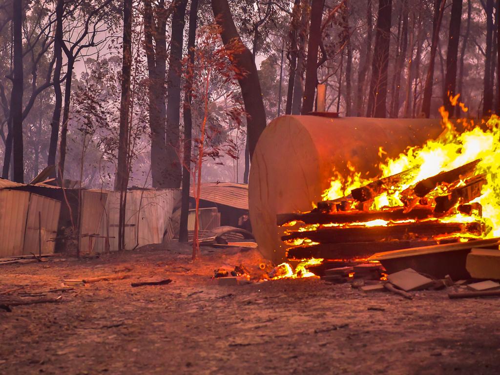 An out of control fire ripped through the Blue Mountains this afternoon. Unknown houses and other property has been destroyed along Bells Line of Road from Bilpin to Mount Tomah and further west. A cabin at Wollemi Cabins continues to burn well after the fire front has past through. Picture: Matrix