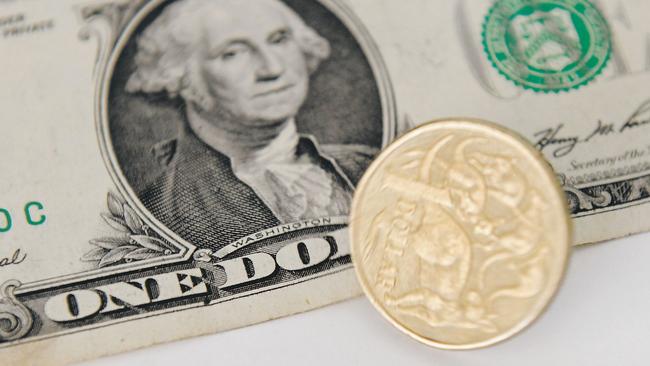 A 1 Australian Dollar coin and a 1 US Dollar note are seen in Canberra, Tuesday, May 21, 2013. As the US economy rebounds, there are predictions that the Australian dollar could fall as low as 90 US cents in the coming weeks and months. (AAP Image/Lukas Coch) NO ARCHIVING