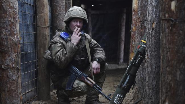 A Ukrainian soldier smokes in a trench on the frontline in Zaporizhzhia region. Picture: AP