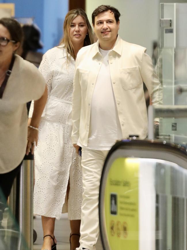 Dressed in white for departure: Higgins and Sharaz left from Brisbane International Airport. Picture: Backgrid