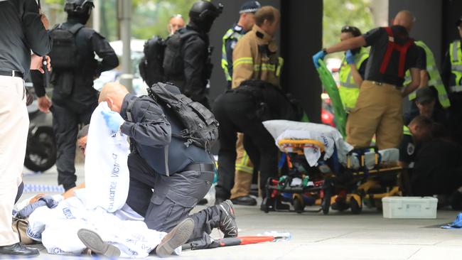 Emergency services crews treat victims of the tragedy. Picture: Alex Coppel