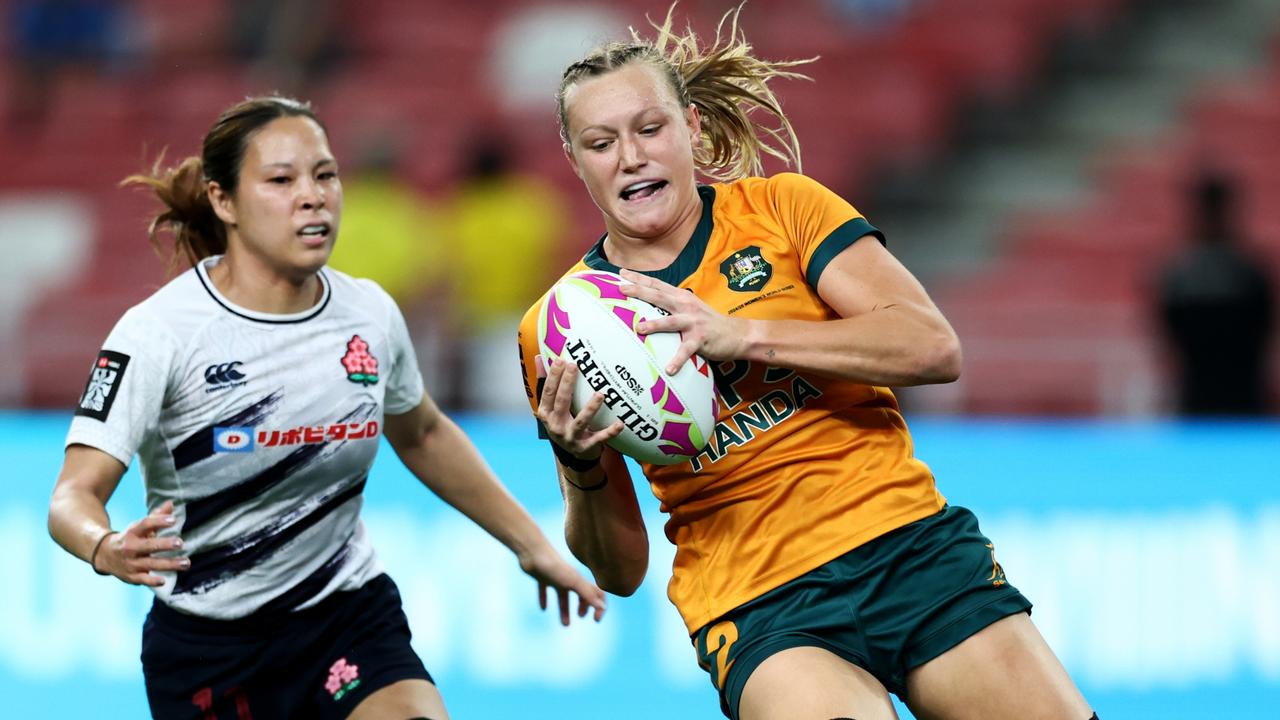 Maddison Levi of Australia scores a try against Japan during the women's pool B match on day one of the HSBC SVNS Singapore. (Photo by Yong Teck Lim/Getty Images)