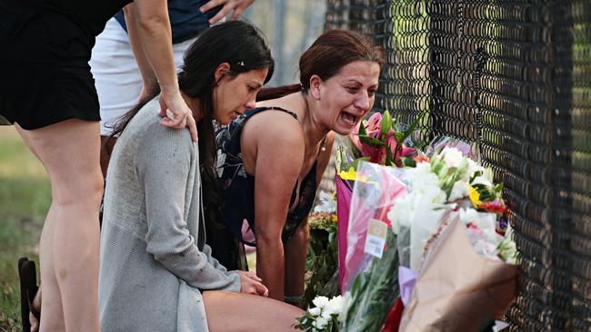 The mother of three of the children, Leila Geagea (left), grieving at the site with relatives on Sunday morning. Picture: Adam Yip