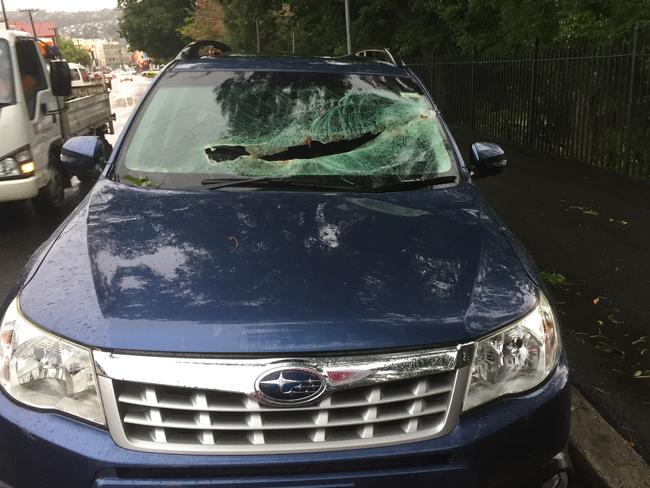 A car in Launceston has its front windscreen smashed in the wild weather. Picture: NICK CLARK