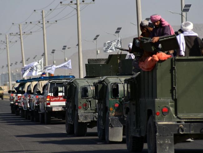 Taliban fighters stand on an armoured vehicle in Kandahar on September 1, 2021 following the Islamist group’s military takeover of the country. Picture: JAVED TANVEER / AFP.