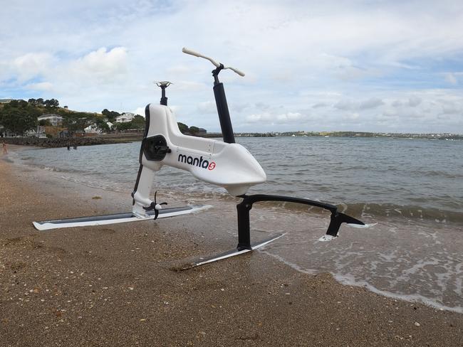 Technology journalist at The Australian Chris Griffith test rides the Hydrofoiler XE-1 by Manta5, an electric bike that planes across water, at Devonport beach in Auckland, New Zealand, on February 15, 2020.