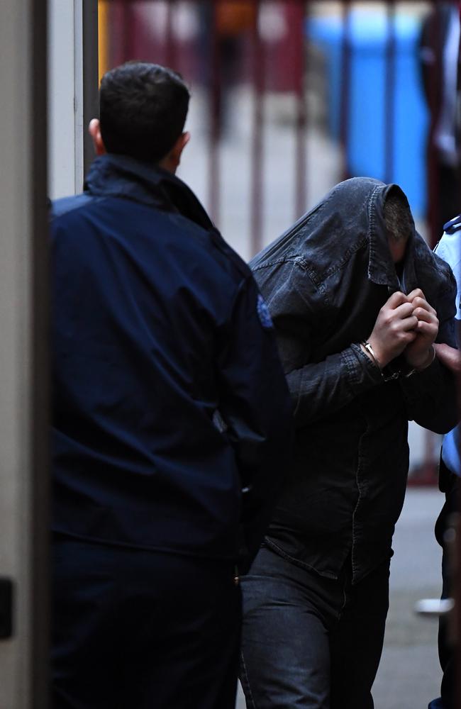 Jaymes Todd arrives to the Supreme Court of Victoria today, shielding his face. Picture: James Ross/AAP