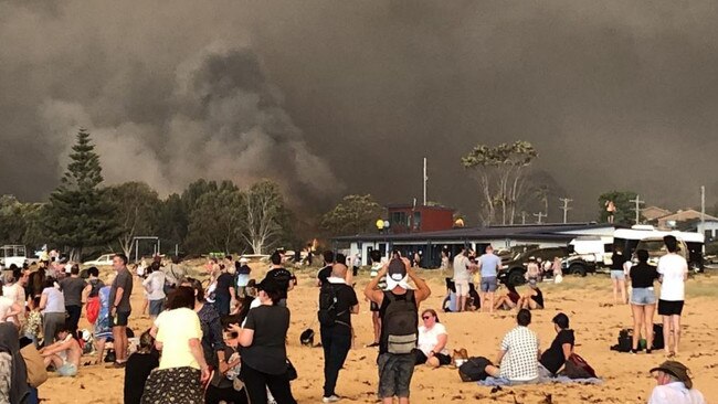 Evacuees take cover at Malua Bay after fire tore through the small town on New Year’s Eve, 2019.