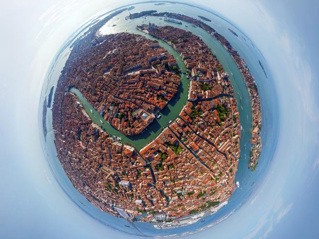 **PLEASE USE CORRECT BYLINE** PIC FROM AIRPANO / CATERSNEWS - (PICTURED: - The winding canals of Venice, Italy) Some of the worlds most iconic cities have been photographed as youve never seen them before in the shape of tiny round planets. By using a pioneering method of aerial photography, each location can be now seen at a full 360 degree angle. After some skilful manipulation on Photoshop known technically as stereographic projection, each sweeping panorama is then turned into a small circular shaped image. Whether its the Eiffel Tower, The Empire State Building or the Shanghai Skyline, each image manages to show hundreds of miles of city landscape. SEE CATERS COPY