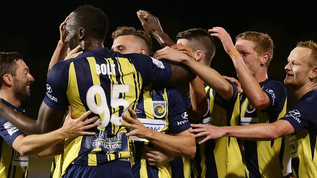 Usain Bolt is congratulated by his Central Coast Mariners teammates after he scored his first goal on Friday night. Picture: Brett Costello