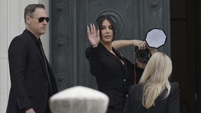 Kim Kardashian waves as she arrives to testify. Picture: AP /Aurelien Morissard