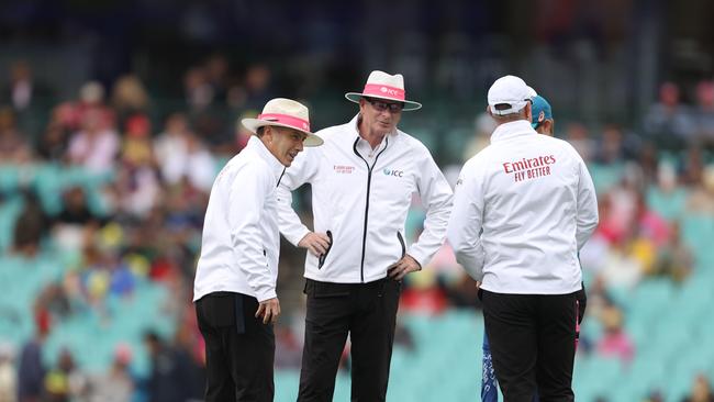 Umpires Paul Reiffel and Chris Gaffaney (L) talk during a rain delay on Thursday. Picture: Getty