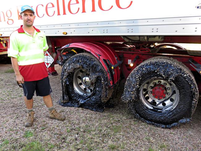 Lindsay Transport truck driver Scott Sargent with his ruined tyres. Picture: David Anthony