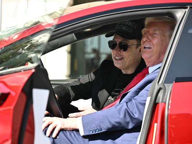 US President Donald Trump and Tesla CEO Elon Musk speak to the press as they sit in a Tesla vehicle on the South Portico of the White House. Picture: AFP