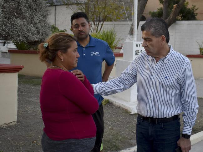 Coahuila Governor Miguel Riquelme Solis, right, talks to a woman who said her son was missing after a gunbattle between Mexican security forces and suspected cartel gunmen in Villa Union, Mexico. Picture: AP Photo