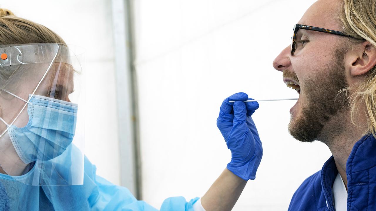 A member of the medical staff in protective gear takes a swab for a COVID-19 test at a test facility in a tent outside Skane University Hospital in Lund, Sweden. Picture: AFP