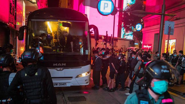 Hong Kong Police detain people on a bus after they cleared protesters taking part in a rally against a new national security law in Hong Kong. Picture: Dale De La Rey/AFP