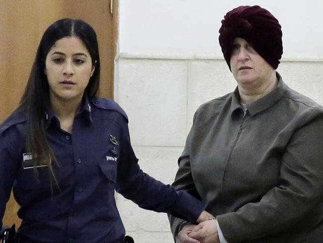 Australian Malka Leifer is brought to a courtroom in Jerusalem, Tuesday, Feb. 27, 2018. An Israeli court says an Australian woman accused of sex crimes will not be extradited for reasons of mental illness. (AP Photo/Mahmoud Illean)