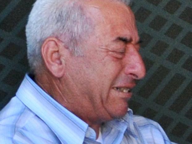 A distressed pensioner sits on the ground outside a national bank branch, as banks opened only for pensioners to allow them to withdraw their pensions, with a limit of 120 euros, in Thessaloniki, on July 3, 2015. Greece is almost evenly split over a crucial weekend referendum that could decide its financial fate, with a 'Yes' result possibly ahead by a whisker, the latest survey Friday showed. Prime Minister Alexis Tsipras's government is asking Greece's voters to vote 'No' to a technically phrased question asking if they are willing to accept more tough austerity conditions from international creditors in exchange for bailout funds. AFP PHOTO /SAKIS MITROLIDIS