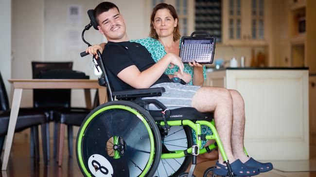 Amanda Coll with her son Finley and the device he uses to communicate. Picture: Matt Turner