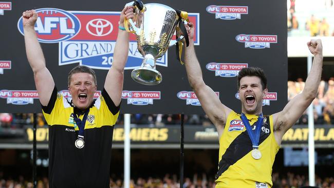 Tigers coach Damien Hardwick and captain Trent Cotchin hold the cup aloft. Pic: Michael Klein