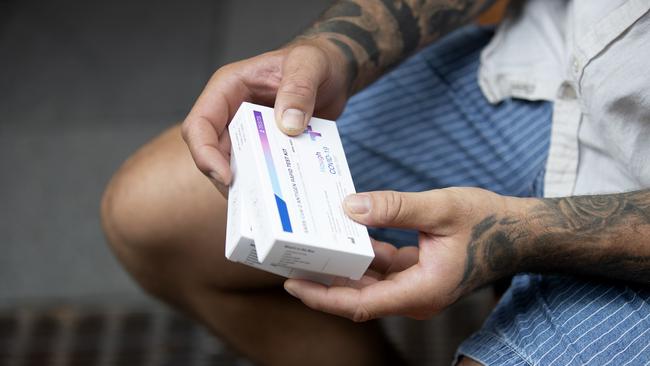 A customer holds his (RAT) rapid antigen tests after purchasing them from a chemist in Sydney. Picture: NCA NewsWire / Nikki Short