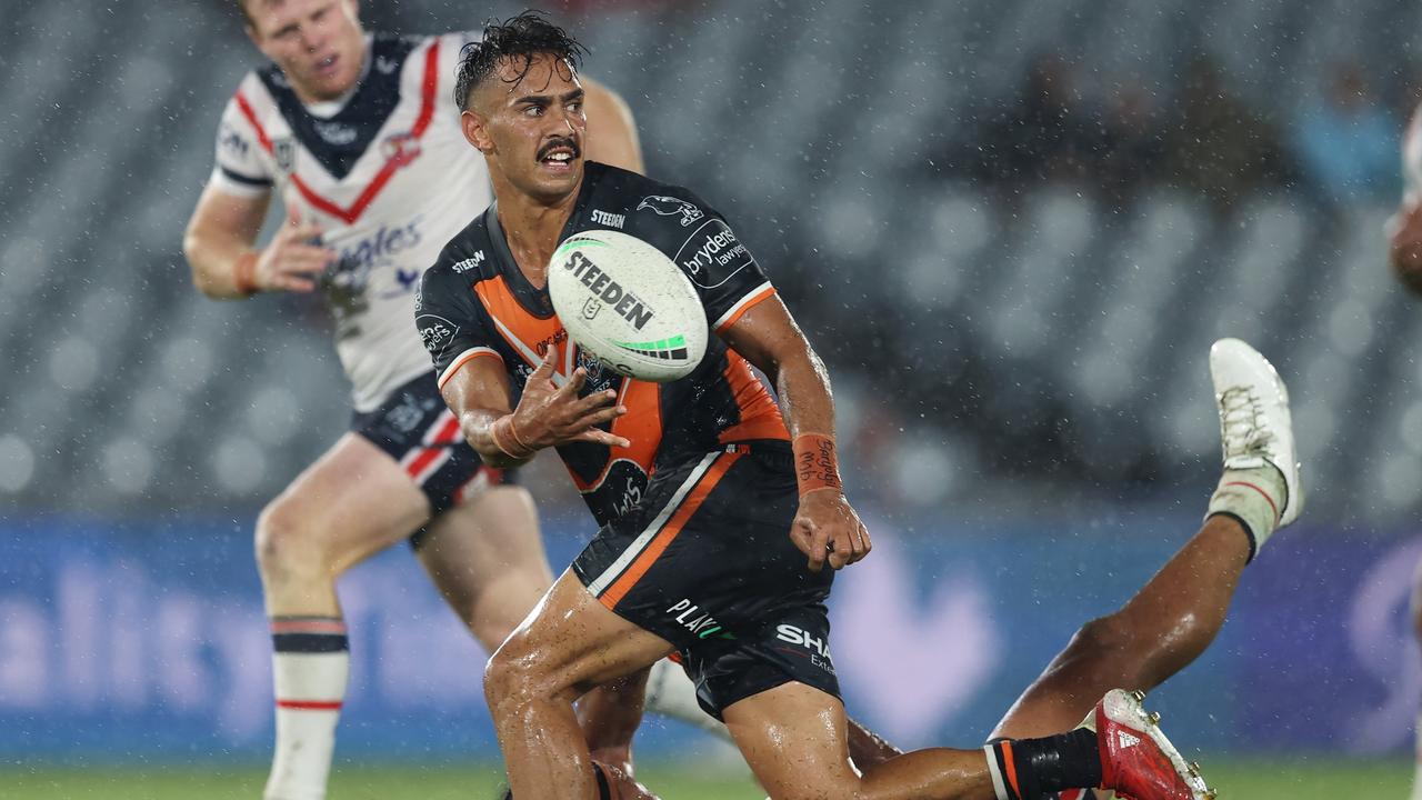 Daine Laurie slips a pass away in the wet conditions at Central Coast Stadium. Picture: Ashley Feder/Getty Images