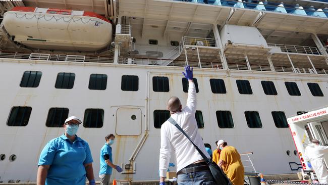 The disembarking crew waved goodbye as their co-workers cheered in relief. Picture: NSW Police