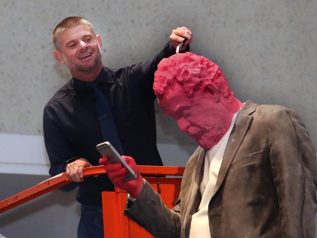 National Gallery of Australia director Nick Mitzevich lighting Francesco, Swiss artist Urs Fischer’s constantly disintegrating and renewing sculpture. Picture Gary Ramage