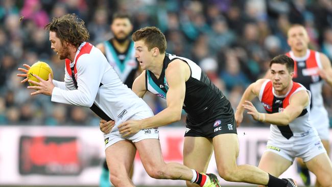 Jack Trengove tackles Saints gun Jack Steven on Saturday. Picture: AAP Image/David Mariuz