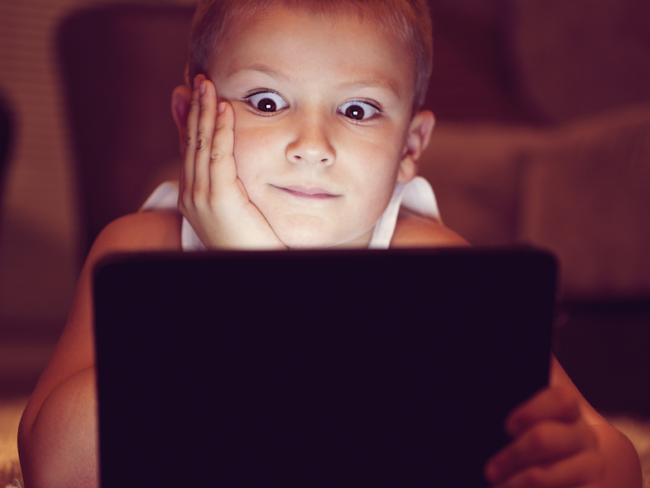 Generic image of a child looking at a tablet or iPad. Photo from iStock.