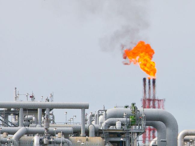 A flame blazes on top of flare stacks at a plant at the Queensland Curtis Liquefied Natural Gas (QCLNG) project site, operated by QGC Pty, a unit of Royal Dutch Shell Plc, in Gladstone, Australia, on Wednesday, June 15, 2016. Gas from more than 2,500 wells travels hundreds of miles by pipeline to the project, where it's chilled and pumped into 10-story-high tanks before being loaded onto massive ships. Photographer: Patrick Hamilton/Bloomberg via Getty Images