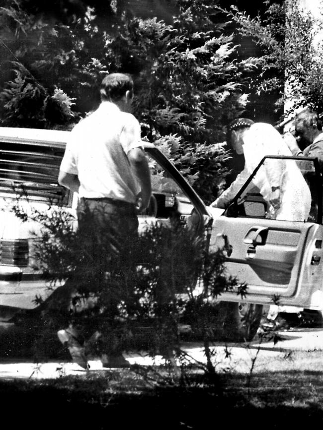 Police searching Mr Winchester’s car after he was shot dead outside his Canberra home.