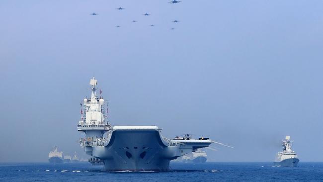 Chinese warships and fighter jets take part in a military display in the South China Sea. Picture: Reuters