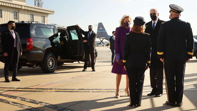 Joe Biden (2nd R) and his wife Dr Jill Biden talk with members of the military before boarding their flight for Washington at the New Castle County Airport in Delaware. Picture: AFP.