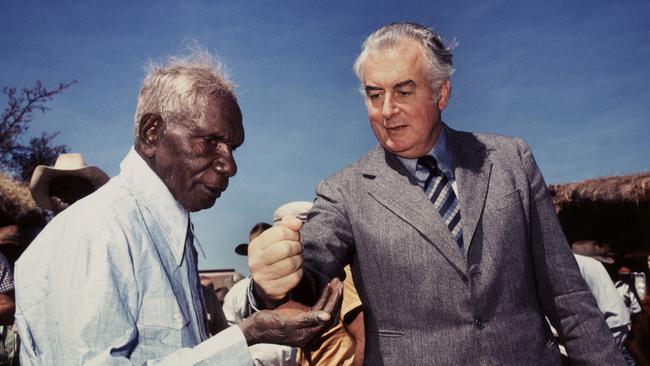 Gough Whitlam symbolically pours soil into the hands of land rights hero Vincent Lingiari during his visit to the Northern Territory in 1975. Picture: Mervyn Bishop