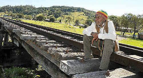 Bundjalung spokesperson Robert Corowa sits in front of what he says is the Sleeping Lizard sacred Aboriginal site in North Lismore, which is proposed for development. . Picture: Jacklyn Wagner