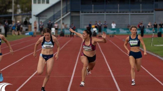 Caboolture's Elly Buckholz, who trains at Mayne Harriers, throws her hands in the air after winning the 100m at the All Schools nationals in Cairns, 2018.