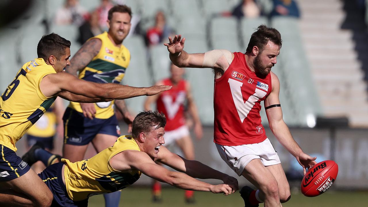 16/09/18 - SANFL - Preliminary Final - Eagles v North Adelaide at the Adelaide Oval. Max Thring gets his kick away from Jared Petrenko and Nicholas Hayes. Picture SARAH REED