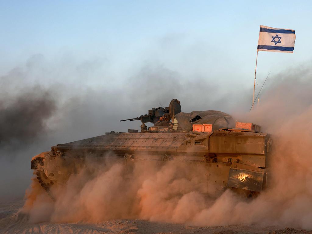 An Israeli military armoured vehicle rolls in an area bordering the Gaza Strip. Picture: AFP