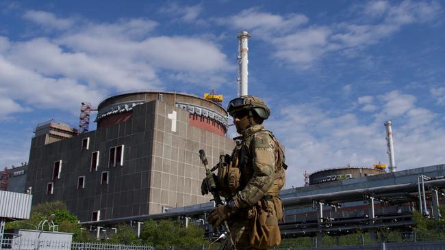 (FILES) In this file photo taken on May 1, 2022, A Russian serviceman patrols the territory of the Zaporizhzhia Nuclear Power Station in Energodar. - Kyiv on August 8, 2022, called for the establishment of a demilitarised zone around the nuclear power station in east Ukraine, where recent fighting with Russian forces has raised fears of a nuclear accident. The Kremlin on August 8, 2022, accused Ukrainian forces of firing on the Zaporizhzhia atomic power plant, warning of potential "catastrophic consequences" for Europe. *EDITOR'S NOTE: This picture was taken during a media trip organised by the Russian army.* (Photo by Andrey BORODULIN / AFP)