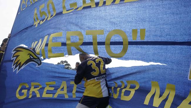 Tony Mertis breaks the banner for his 450th match for Doveton Eagles. Picture: Valeriu Campan