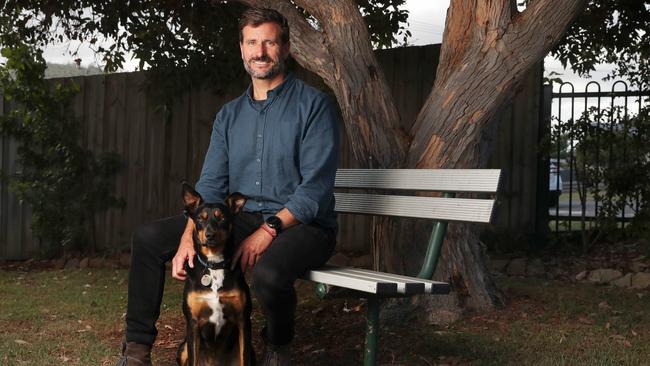 Ben Cooper with his dog Macy. Macy spends many days at the centre and has helped to make clients feel at ease. Warrane Mornington Neighbourhood Centre. Picture: Nikki Davis-Jones